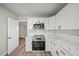 Modern kitchen with white cabinets, marble counters and stainless steel appliances at 602 E Orange St, Auburndale, FL 33823