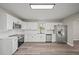 Well-lit kitchen with white cabinetry and stainless steel appliances at 602 E Orange St, Auburndale, FL 33823