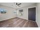 Open floor plan featuring light neutral walls, laminate wood flooring, and a ceiling fan at 602 E Orange St, Auburndale, FL 33823