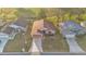 Aerial shot of a home with a well-kept lawn, two-car garage, and proximity to a green space, surrounded by neighborhood at 6224 Crane Dr, Lakeland, FL 33809