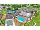 Aerial view of a community pool, shuffleboard courts, and tennis courts in a well-maintained neighborhood at 6224 Crane Dr, Lakeland, FL 33809