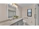 Bathroom featuring gray vanity with marble top and updated shower at 6224 Crane Dr, Lakeland, FL 33809