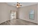 Bedroom with sliding glass doors and wood-look flooring at 6224 Crane Dr, Lakeland, FL 33809