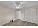 Bedroom features wood-look flooring, a ceiling fan, and double door closet, with neutral paint at 6224 Crane Dr, Lakeland, FL 33809