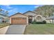 Charming single-story home with a well-maintained lawn, complemented by a two-car garage and neutral color scheme at 6224 Crane Dr, Lakeland, FL 33809