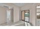 Neutral hallway with sliding glass door with view of the golf course and view of the nearby bathroom at 6224 Crane Dr, Lakeland, FL 33809