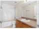 A well-lit bathroom featuring a bathtub and a vanity with a large mirror at 623 Nicholson Dr, Davenport, FL 33837