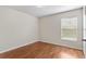 A clean bedroom with hardwood floors and natural light from a window at 623 Nicholson Dr, Davenport, FL 33837