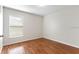 This minimalist bedroom boasts hardwood floors and a bright, airy ambiance at 623 Nicholson Dr, Davenport, FL 33837