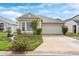 Charming single-story home with a well-manicured front yard and two-car garage at 623 Nicholson Dr, Davenport, FL 33837