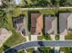 Bird's-eye view of residences featuring a paved driveway, manicured lawn, and verdant landscaping around the property at 6271 Res Cir, Lakeland, FL 33810