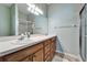 Bathroom featuring double sinks, a vanity and a walk-in shower at 6271 Res Cir, Lakeland, FL 33810