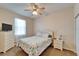 Comfortable bedroom with a ceiling fan, floral comforter, and dresser, creating a relaxing retreat at 6271 Res Cir, Lakeland, FL 33810