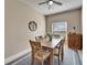 Well lit dining room with wood table, seating for six and a view to the yard at 6271 Res Cir, Lakeland, FL 33810