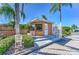 Community guardhouse and gate with palm trees on a clear day at 6271 Res Cir, Lakeland, FL 33810