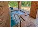 Inviting in-ground hot tub with clear water and a convenient handrail, surrounded by tiled decking at 6271 Res Cir, Lakeland, FL 33810