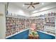 Cozy library featuring floor-to-ceiling bookshelves, a comfy chair, and blue carpet at 6271 Res Cir, Lakeland, FL 33810