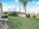 Backyard featuring a well-maintained lawn, plants, and a privacy wall at 6337 Egret Dr, Lakeland, FL 33809