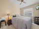 Neutral colored bedroom with ceiling fan, window, and a comfortable bed at 6337 Egret Dr, Lakeland, FL 33809