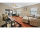 Cozy living room with wood-look flooring, a ceiling fan, and a sliding glass door at 6337 Egret Dr, Lakeland, FL 33809