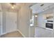 View of the entryway with a bright white front door leading to a modern kitchen and dining area at 6610 Shepherd Oaks St, Lakeland, FL 33811