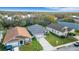 Aerial view of house with manicured lawn, paved driveway, mature trees, and tasteful landscaping at 6838 Shimmering Dr, Lakeland, FL 33813