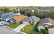 Aerial view of house featuring a well-manicured lawn, a paved driveway, and mature landscaping at 6838 Shimmering Dr, Lakeland, FL 33813