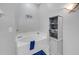 Bright bathroom featuring a soaking tub, storage cabinet and soft gray paint at 6838 Shimmering Dr, Lakeland, FL 33813