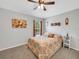 Nicely appointed bedroom with ceiling fan and patterned bedspread at 6838 Shimmering Dr, Lakeland, FL 33813