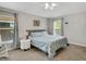 Light-filled bedroom with ceiling fan, neutral walls, and carpeted floors at 6838 Shimmering Dr, Lakeland, FL 33813