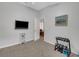 Neutral bedroom featuring medium tone carpet and a television mounted on the wall at 6838 Shimmering Dr, Lakeland, FL 33813