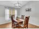 Dining room with a modern light fixture and hardwood floors at 6838 Shimmering Dr, Lakeland, FL 33813