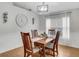 Charming dining room with a chandelier, hardwood floors, and bright windows at 6838 Shimmering Dr, Lakeland, FL 33813