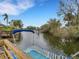 Water view from boat featuring dock, boat lift and lush green trees at 6838 Shimmering Dr, Lakeland, FL 33813