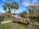 Waterfront backyard with dock, boat lift, canal and mature palm trees at 6838 Shimmering Dr, Lakeland, FL 33813