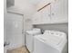 Well-lit laundry room featuring washer, dryer, storage cabinets and a door to the outside at 6838 Shimmering Dr, Lakeland, FL 33813