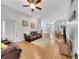 Cozy living room with hardwood floors, ceiling fan, and stylish decor open to dining and kitchen area at 6838 Shimmering Dr, Lakeland, FL 33813