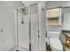 Walk-in shower with glass doors and white tile, adjacent to toilet at 6838 Shimmering Dr, Lakeland, FL 33813