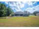 Expansive backyard featuring a well-manicured lawn and an inviting screened-in porch for outdoor enjoyment at 6846 Ashbury Dr, Lakeland, FL 33809