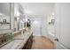 Modern bathroom with granite counters, double sinks, a shower, and a soaking tub at 6846 Ashbury Dr, Lakeland, FL 33809