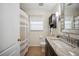 Bright bathroom with a shower and a granite-topped vanity with cabinet at 6846 Ashbury Dr, Lakeland, FL 33809