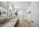 Modern bathroom with granite counters, double sinks, a shower, and a soaking tub at 6846 Ashbury Dr, Lakeland, FL 33809