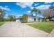 Charming single-story home with a spacious driveway and lush landscaping at 6846 Ashbury Dr, Lakeland, FL 33809