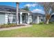 Attractive home exterior featuring a manicured lawn, a palm tree, and decorative plants enhancing the home's curb appeal at 6846 Ashbury Dr, Lakeland, FL 33809