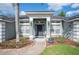 Inviting entrance with a covered front porch, complemented by landscaped flower beds and a sidewalk at 6846 Ashbury Dr, Lakeland, FL 33809