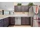 This kitchen features stainless steel appliances, dark cabinets, and light countertops at 6846 Ashbury Dr, Lakeland, FL 33809