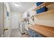 Organized laundry room featuring washer and dryer, utility sink, folding counter, and plenty of storage shelving at 6846 Ashbury Dr, Lakeland, FL 33809