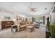 Bright living room featuring neutral carpet, large sectional sofa, and large window with views to the backyard at 6846 Ashbury Dr, Lakeland, FL 33809