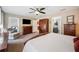 Cozy main bedroom with ensuite bathroom, balcony access, and wood furnishings at 6846 Ashbury Dr, Lakeland, FL 33809