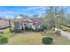 Aerial view of a beautiful home with lush green lawn and mature trees, showcasing its serene setting at 6942 Indian Creek Park Dr, Lakeland, FL 33813